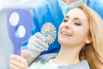 woman choosing a shade for her dental implants