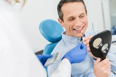 man choosing his dental veneer color at Pendleton Smiles