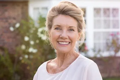 woman smiling after crowns restored her smile